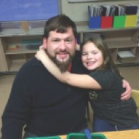 Crocker Elementary School second-grader, Scarlett Brooks, hugs her father, Matt, during ÒCrazy 8s Math Club.Ó